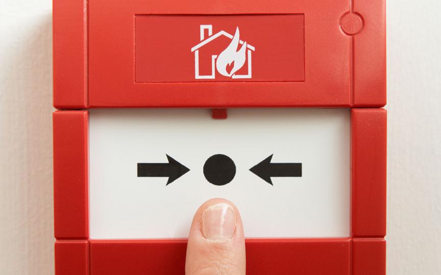 Image of emergency fire alarm box installed on a wall. 