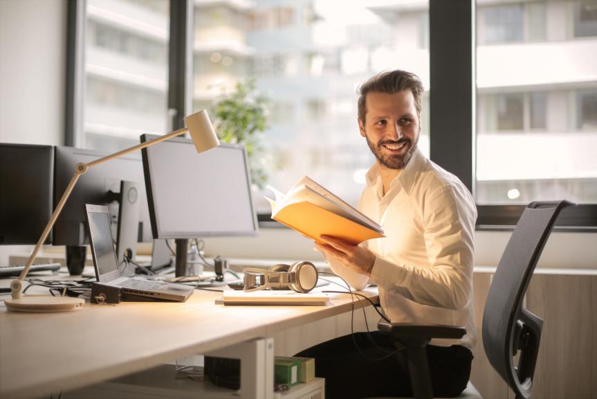 Man Sat at Desk Smiling